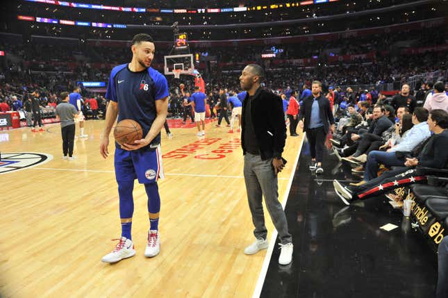 Agent Rich Paul talks to his client Ben Simmons during halftime of a basketball game between the Los Angeles Clippers and the Philadelphia 76ers at Staples Center on January 01, 2019 in Los Angeles, California. 