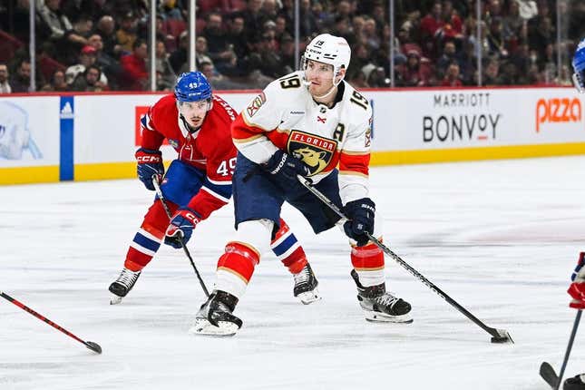 Mar 30, 2023; Montreal, Quebec, CAN; Florida Panthers left wing Matthew Tkachuk (19) plays the puck against Montreal Canadiens left wing Rafael Harvey-Pinard (49) during the third period at Bell Centre.