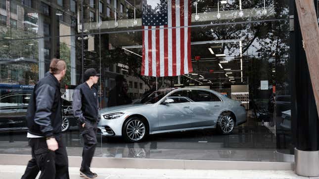 ew cars are showcased in the window of a car dealership on October 05, 2021 in New York City.