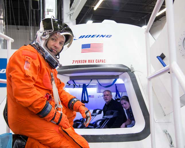 NASA astronaut Randy Bresnik prepares to enter Boeing's CST-100 spacecraft for a fit check evaluation at the company's Houston Product Support Center in this undated image. NASA will partner with Boeing and SpaceX to build commercially owned and operated "space taxis" to fly astronauts to the International Space Station, ending U.S. dependence on Russia for rides, officials said on Tuesday.