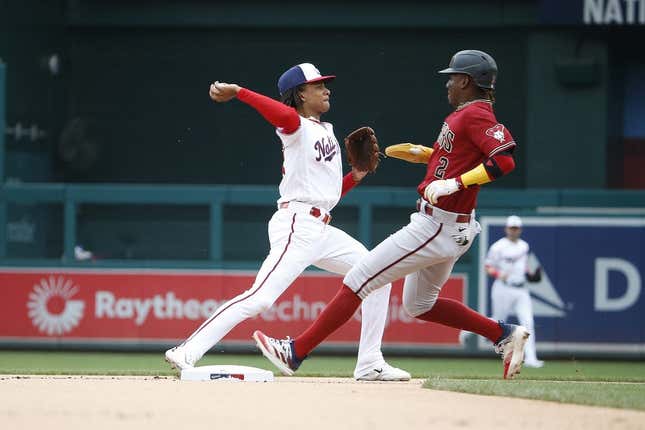 Jun 22, 2023; Washington, District of Columbia, USA; Washington Nationals shortstop CJ Abrams (5) tags out Arizona Diamondbacks shortstop Geraldo Perdomo (2) on second base and throws the ball to first during the first inning at Nationals Park.