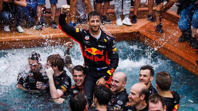 A photo of Daniel Ricciardo and the Red Bull team in a pool.