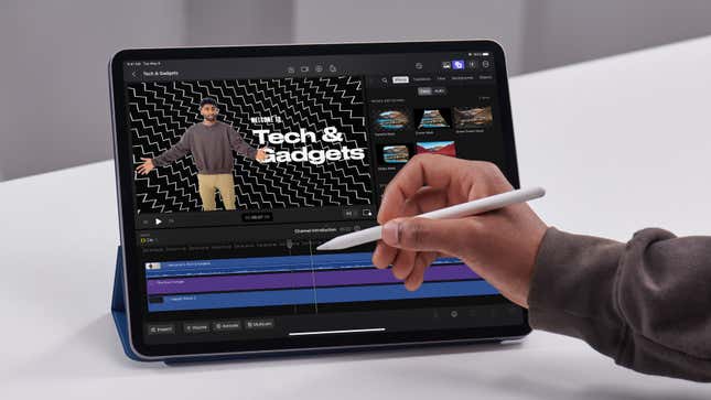 A user running Final Cut Pro for iPad and using the Apple Pencil stylus to navigate the app's timeline.