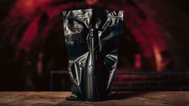 Bottle of wine in black vacuum-sealed packaging with red cave background