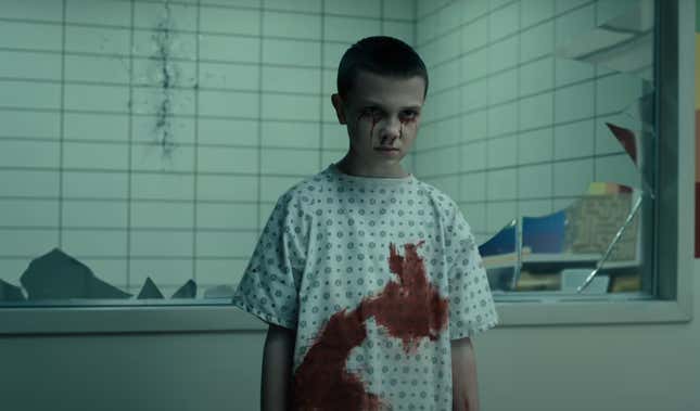 young eleven covered in blood in front of a broken mirror window
