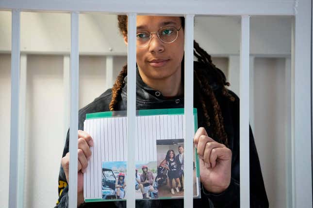 Brittney Griner holds photographs standing inside a defendants’ cage before a hearing at the Khimki Court, outside Moscow on July 26, 2022. (Photo by Alexander Zemlianichenko / POOL / AFP) (Photo by ALEXANDER ZEMLIANICHENKO/POOL/AFP via Getty Images)