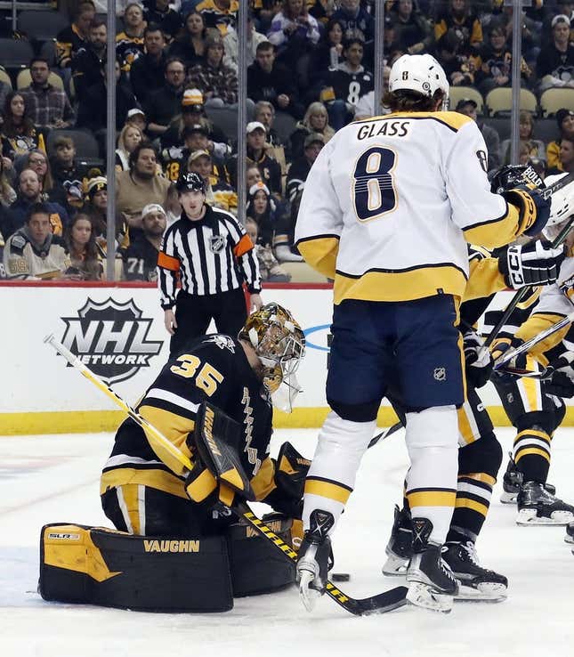 Mar 30, 2023; Pittsburgh, Pennsylvania, USA; Pittsburgh Penguins goaltender Tristan Jarry (35) makes a save behind a screen by Nashville Predators center Cody Glass (8) during the first period at PPG Paints Arena.