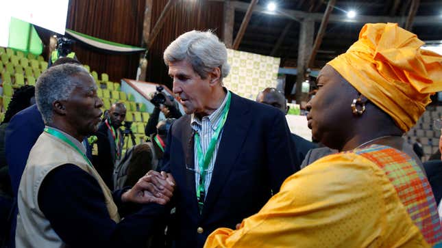Former U.S. Secretary of State John Kerry and former South Africa President Thabo Mbeki, observers for the general election in Kenya, greet each other next to former Senegalese Prime Minister Aminata Toure in a tally centre in Nairobi, Kenya early August 9, 2017.