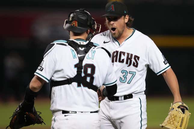 Jul 25, 2023; Phoenix, Arizona, USA; Arizona Diamondbacks relief pitcher Kevin Ginkel (37) celebrates with Arizona Diamondbacks catcher Carson Kelly (18) after defeating the St. Louis Cardinals at Chase Field.