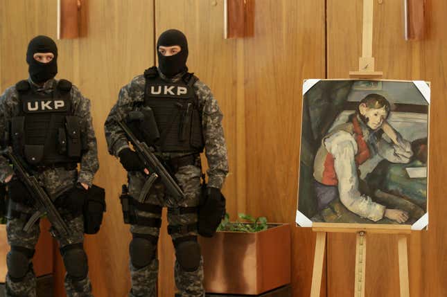 Serbian police guard the stolen “The Boy in the Red Vest” painting by French impressionist Paul Cezanne, in Belgrade.