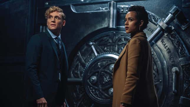Matthias Schweighöfer and Nathalie Emmanuel stand in front of a giant safe in Army of Thieves.