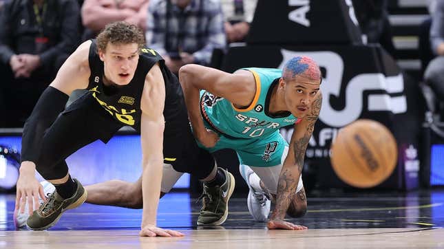 Feb 25, 2023; Salt Lake City, Utah, USA; Utah Jazz forward Lauri Markkanen (23) and San Antonio Spurs forward Jeremy Sochan (10) chase after a loose ball in the second half at Vivint Arena.