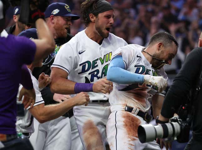 Apr 21, 2023; St. Petersburg, Florida, USA; Tampa Bay Rays second baseman Brandon Lowe (8) celebrates with teammates at home plate as he hits the game winning walk off 2-run home run against the Chicago White Sox at Tropicana Field.