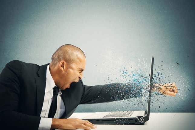 A man punching a computer