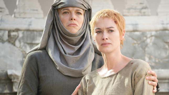Hannah Waddingham in her Septa Unella robes holding Lena Headey's Cersei by the arms.