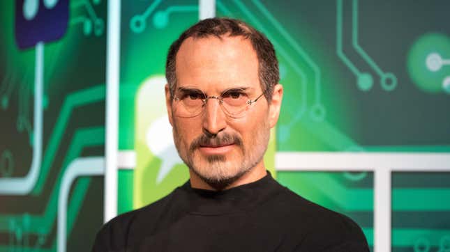 A wax image of Steve Jobs in front of a background of a computer board.