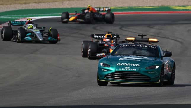 A photo of the Aston Martin safety car leading the Formula 1 pack. 