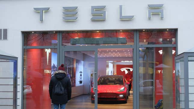  A man satnds outside a Tesla dealership on January 4, 2019 in Berlin, Germany. 