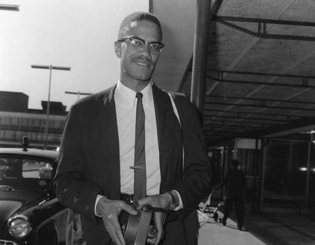 Malcolm X (1925 - 1965), black American Muslim leader, arriving at Heathrow Airport en route to Egypt to attend a meeting of the Organization of African Unity, London, July 9, 1964.