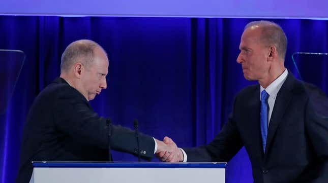 Dixton (left) shakes hands with Boeing chief executive Dennis Muilenburg.