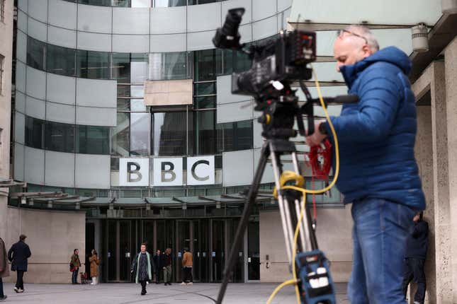 A cameraman readies his equipment in front of London's BBC headquarters