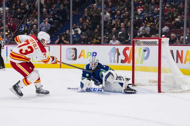 Mar 31, 2023; Vancouver, British Columbia, CAN; Calgary Flames forward Tyler Toffoli (73) scores the overtime winner on Vancouver Canucks goalie Thatcher Demko (35) at Rogers Arena. Calgary won 5-4 on overtime.