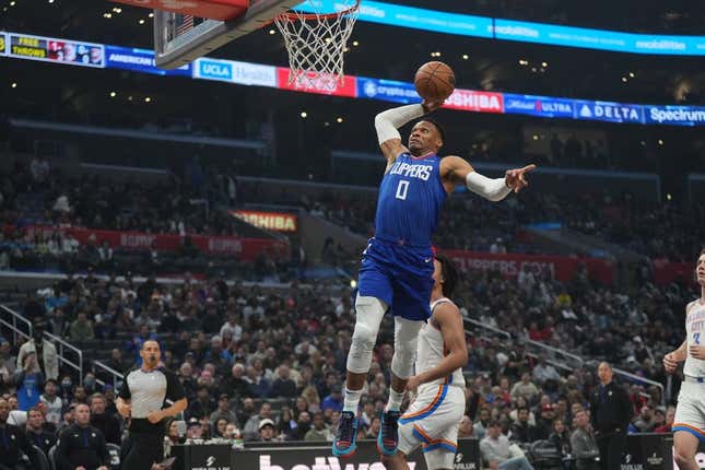 Mar 21, 2023; Los Angeles, California, USA; LA Clippers guard Russell Westbrook (0) dunks the ball against the Oklahoma City Thunder in the first half at Crypto.com Arena.