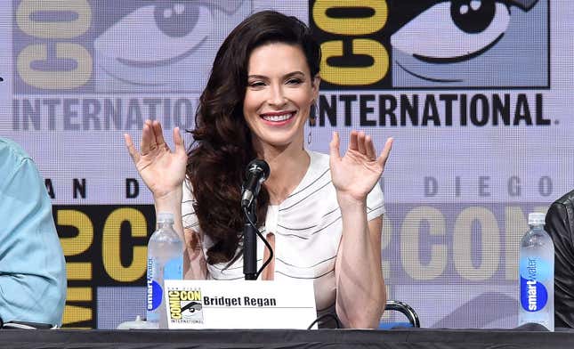 Bridget Regan waves at fans from the stage during a San Diego Comic-Con Panel.