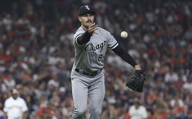 Mar 30, 2023; Houston, Texas, USA; Chicago White Sox starting pitcher Dylan Cease (84) tosses the ball to first base for an out during the fourth inning against the Houston Astros at Minute Maid Park.