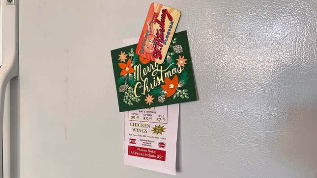 Image for article titled More Fridge Magnets Forced To Take On Extra Holiday Work Holding Up Christmas Cards