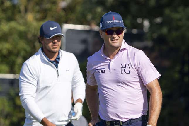 July 17, 2023; Hoylake, ENGLAND, GBR; Brooks Koepka (left) and Zach Johnson (right) watch a tee shot on the fifth hole during a practice round of The Open Championship golf tournament at Royal Liverpool.