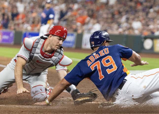 Apr 28, 2023; Houston, Texas, USA; Houston Astros first baseman Jose Abreu (79) is tagged out at home plate by Philadelphia Phillies catcher J.T. Realmuto (10) in the fifth inning at Minute Maid Park.
