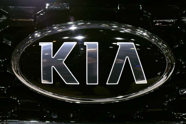 Old Kia badge on the front of a car in 2013