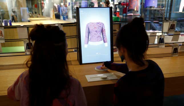 Staff members proceed with the measuring process on a computer to order a knitting pattern at the Adidas Knit for You store in Berlin, Germany March 7, 2017. Picture taken March 7, 2017. REUTERS/Fabrizio Bensch - RTX31WD3