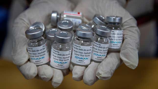 In this May 8, 2021 photo, a health worker displays empty vials of covid-19 vaccines in Gauhati, India. 

