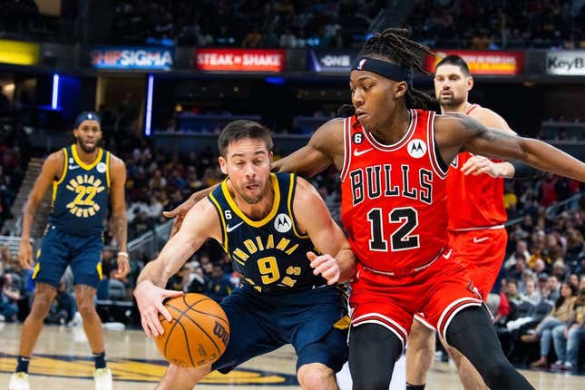 Jan 24, 2023; Indianapolis, Indiana, USA; Indiana Pacers guard T.J. McConnell (9) dribbles the ball while Chicago Bulls guard Ayo Dosunmu (12) defends in the second quarter at Gainbridge Fieldhouse.