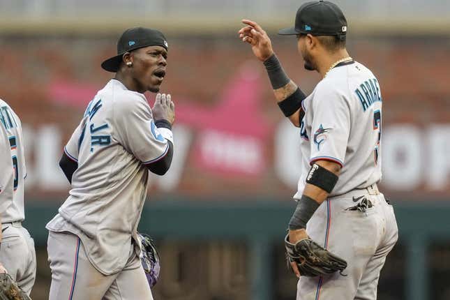 Apr 27, 2023; Cumberland, Georgia, USA; Miami Marlins center fielder Jazz Chisholm Jr. (2) reacts with second baseman Luis Arraez (3) after defeating the Atlanta Braves at Truist Park.