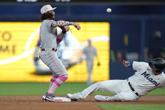 May 14, 2023; Miami, Florida, USA;  Cincinnati Reds second baseman Jonathan India (6) attempts to complete a double play after getting the force out at second base of Miami Marlins first baseman Garrett Cooper (26) in the first inning at loanDepot Park.