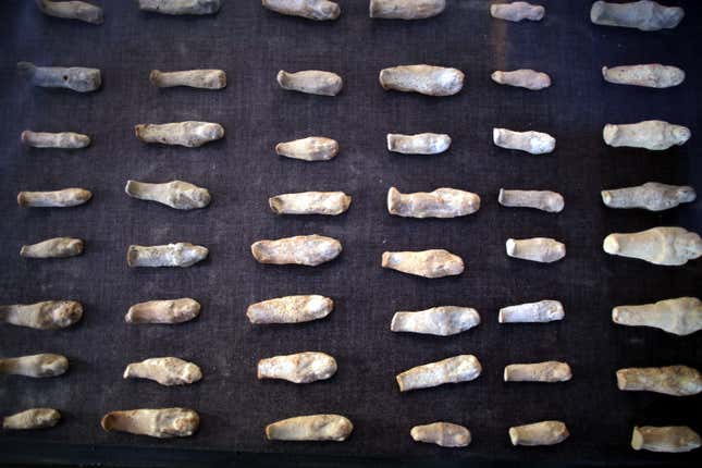 epa06378801 Miniature statues on display at a recently found tomb and re-discovery of older one, at Draa Abul Naga necropolis on Luxor?s west bank, 700km south of Cairo, Egypt, 09 December 2017. Egypt's Ministry of Antiquities announced the discovery of a tomb from the New Kingdom that belongs to the old Egyptian deity Amun's Goldsmith, Amenemhat (tomb number Kampp 390) and a burial shaft housing the mummy of a lady and her two children. The newly discovered tomb includes an entrance located in the courtyard of another Middle Kingdom tomb number Kampp 150. EPA-EFE/KHALED ELFIQI