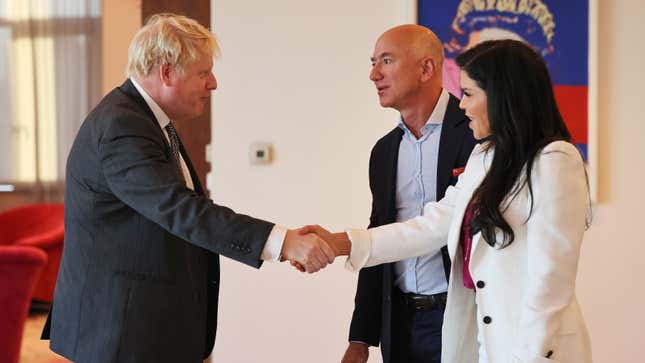 British Prime Minister Boris Johnson greets Amazon founder Jeff Bezos and his girlfriend, Lauren Sanchez, at the UK diplomatic residence on September 20, 2021 in New York City. 