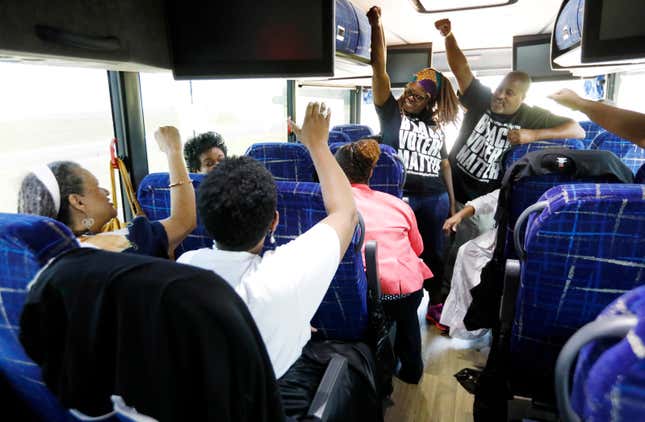 Aug. 24, 2018, file photo, Black Voters Matter Fund co-founders, LaTosha Brown, left, and Cliff Albright, right, lead Mississippi grassroots partners in some empowerment cheers aboard a bus tour to Greenville, Miss.