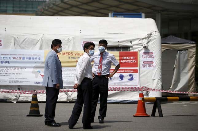 Workers stand in front of a quarantine area set up at a hospital in Seoul.