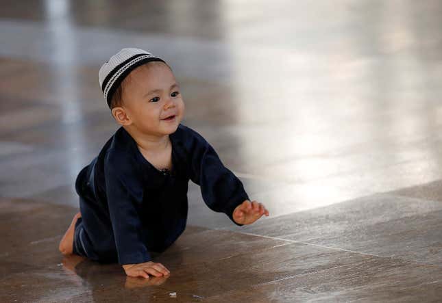 A Muslim child plays during the first day of Eid al Fitr at a mosque in Bangkok, Thailand, on June 15, 2018.