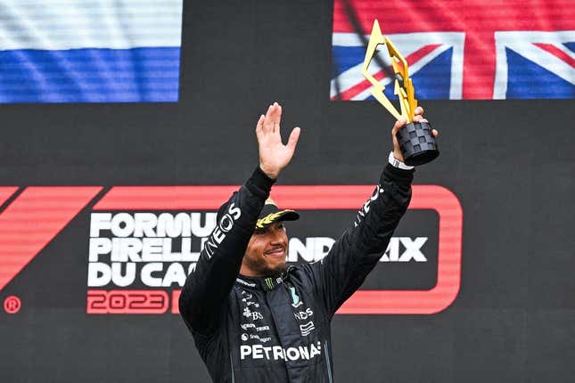 Jun 18, 2023; Montreal, Quebec, CAN; Mercedes driver Lewis Hamilton (GBR) salutes the crowd holding his third place trophy of the Canadian Grand Prix at Circuit Gilles Villeneuve.