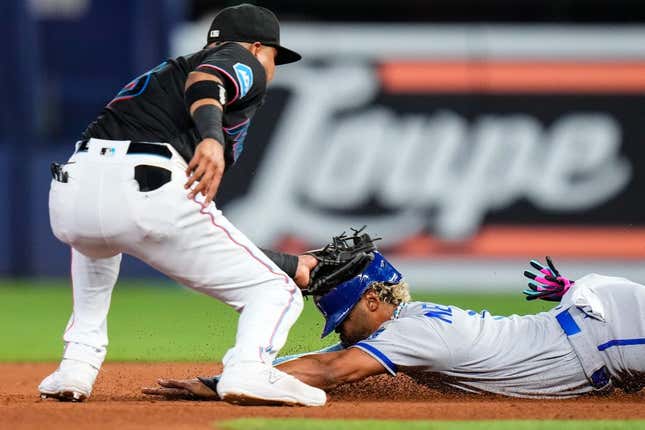 Jun 7, 2023; Miami, Florida, USA; Miami Marlins second baseman Luis Arraez (3) tags out Kansas City Royals right fielder MJ Melendez (1) during the fourth inning at loanDepot Park.