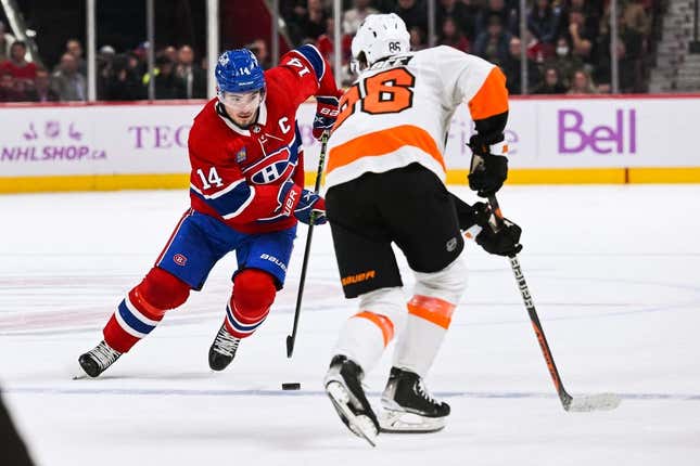 Nov 19, 2022; Montreal, Quebec, CAN; Montreal Canadiens center Nick Suzuki (14) against Philadelphia Flyers left wing Joel Farabee (86) during overtime at Bell Centre.