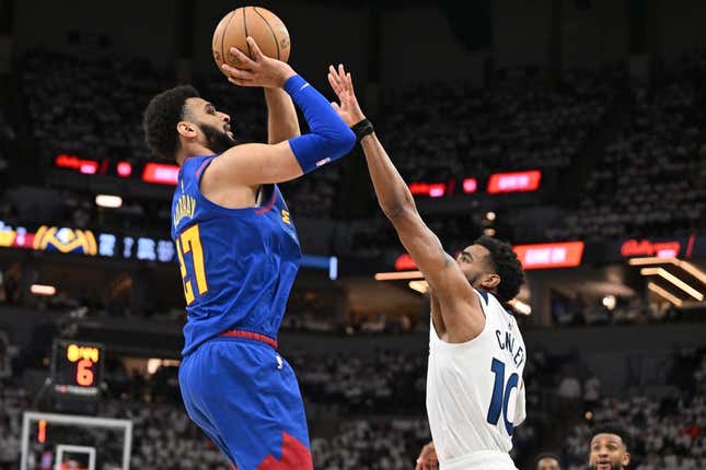 Apr 21, 2023; Minneapolis, Minnesota, USA; Denver Nuggets guard Jamal Murray (27) is defended by Minnesota Timberwolves guard Mike Conley (10) during the second quarter of game three of the 2023 NBA Playoffs at Target Center.
