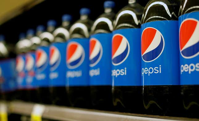Shelf of Pepsi bottles.