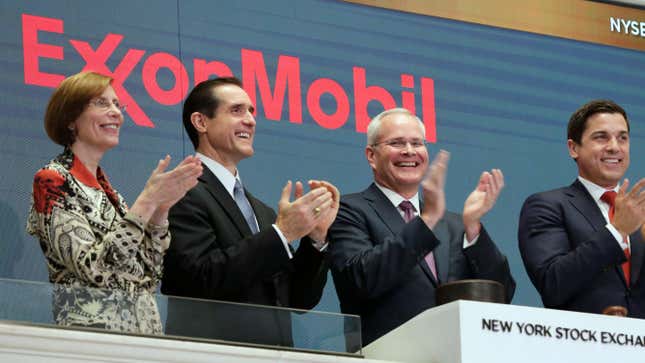 Exxon Chairman and CEO Darren Woods joins the applause during opening bell ceremonies at the New York Stock Exchange.