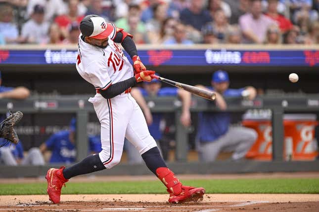 Jul 3, 2023; Minneapolis, Minnesota, USA;  Minnesota Twins designated hitter Byron Buxton (25) hits a sacrifice RBI against the Kansas City Royals during the first inning at Target Field.